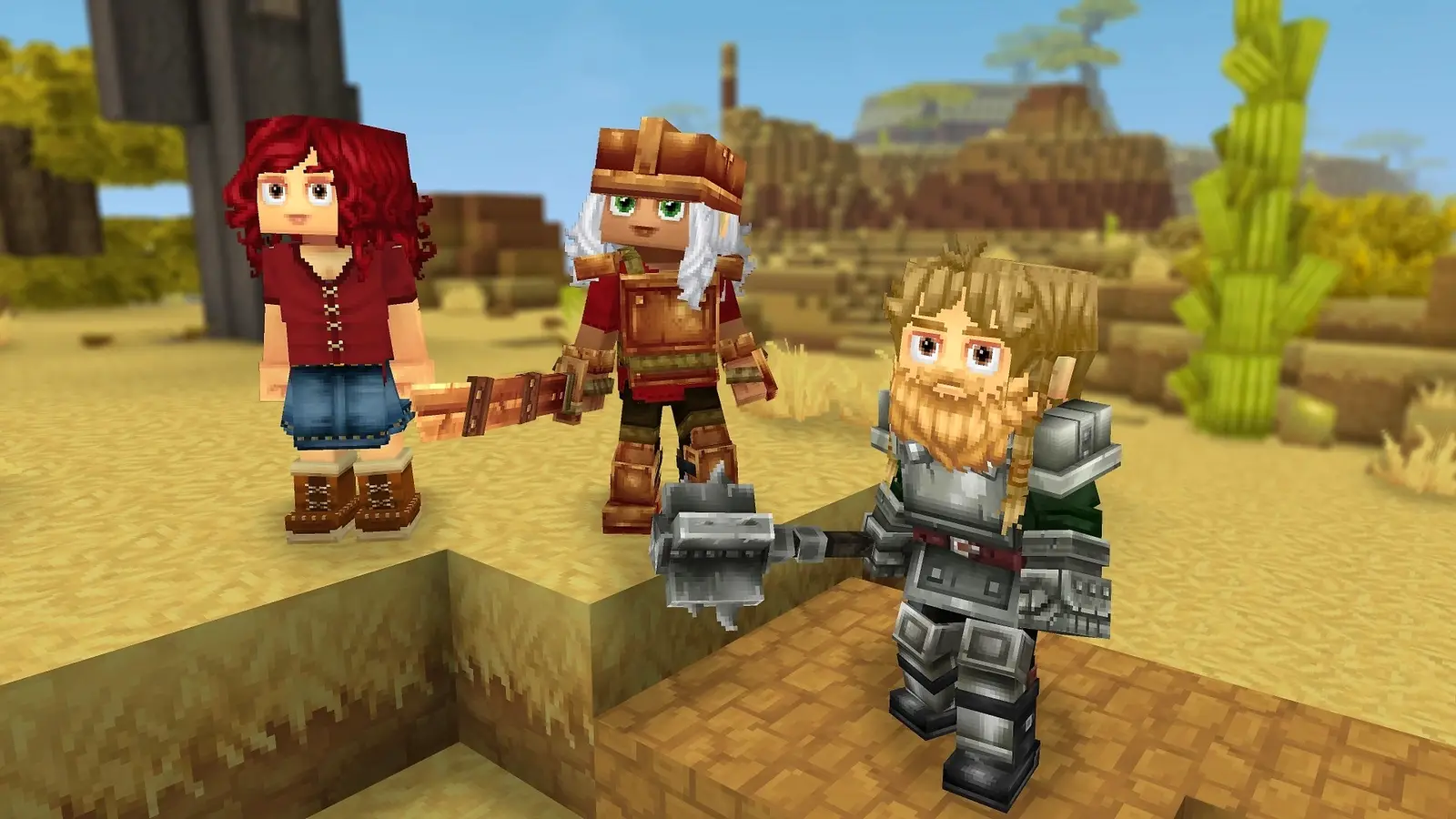 Three player characters stand on sand blocks in a Hytale desert: one with red curly hair in a red top and denim skirt, one with white hair in orange-brown armor holding a sword, and a bearded one in silver plate armor holding a spiked mace, with a cactus and sandstone mesas behind