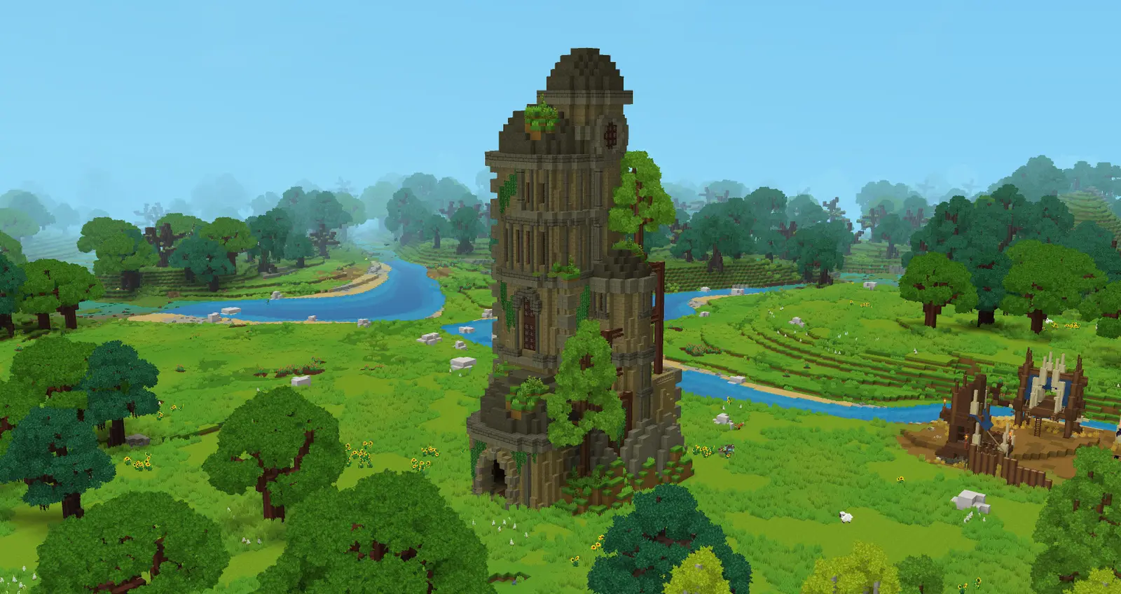 A tall ruined mage tower with trees growing from its walls rises over green fields and a winding river in Zone 1 of Hytale